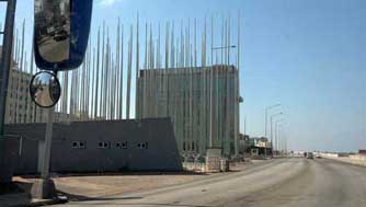 Former U.S. Embassy - In January 2006, the Embassy began displaying messages on a scrolling electronic billboard in the windows of the top floor. Following a protest march, the Cuban government erected a large number of poles, carrying black flags with single white stars to obscure the US Interests Section's electronic billboard.